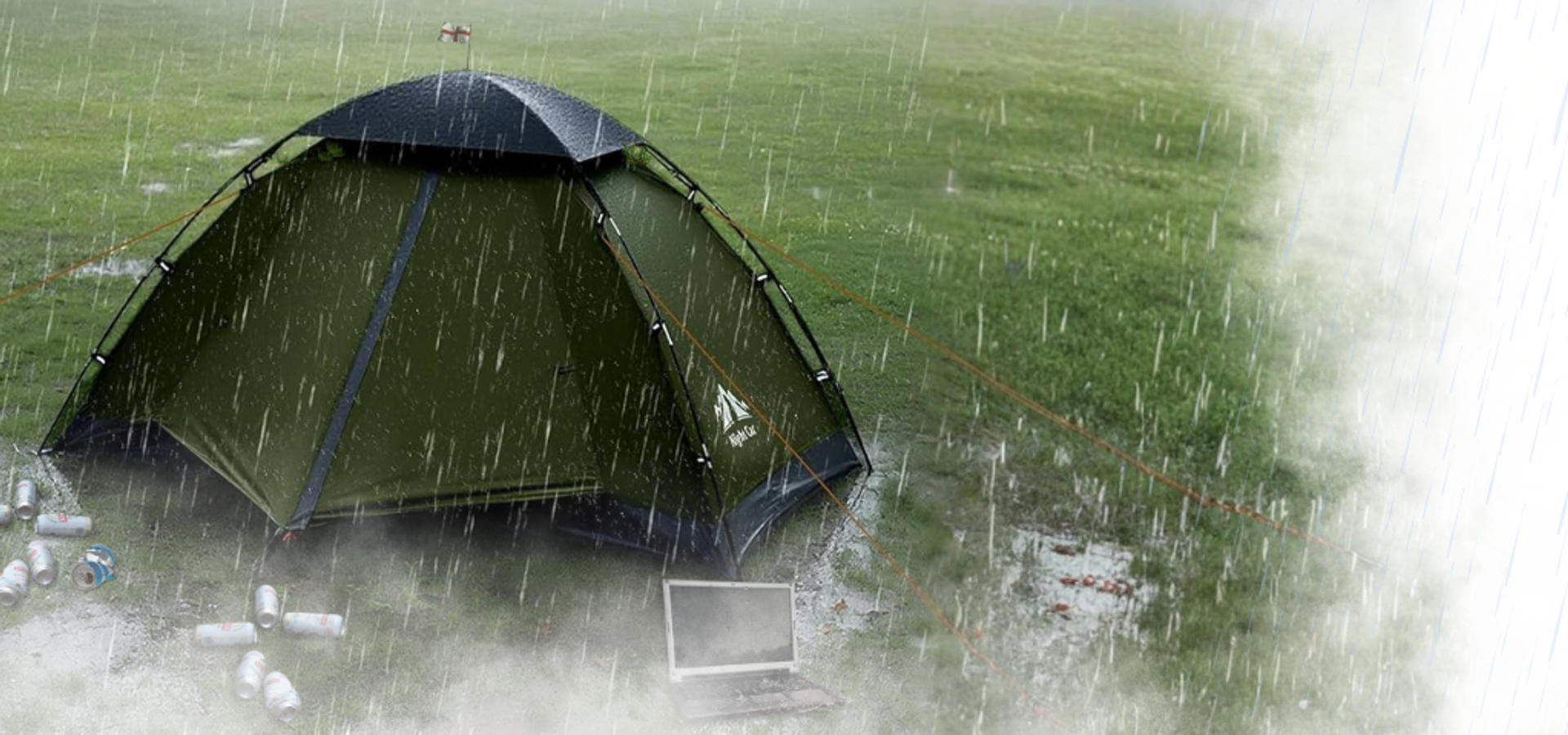A lone tent sits in a rainy waterlogged field.